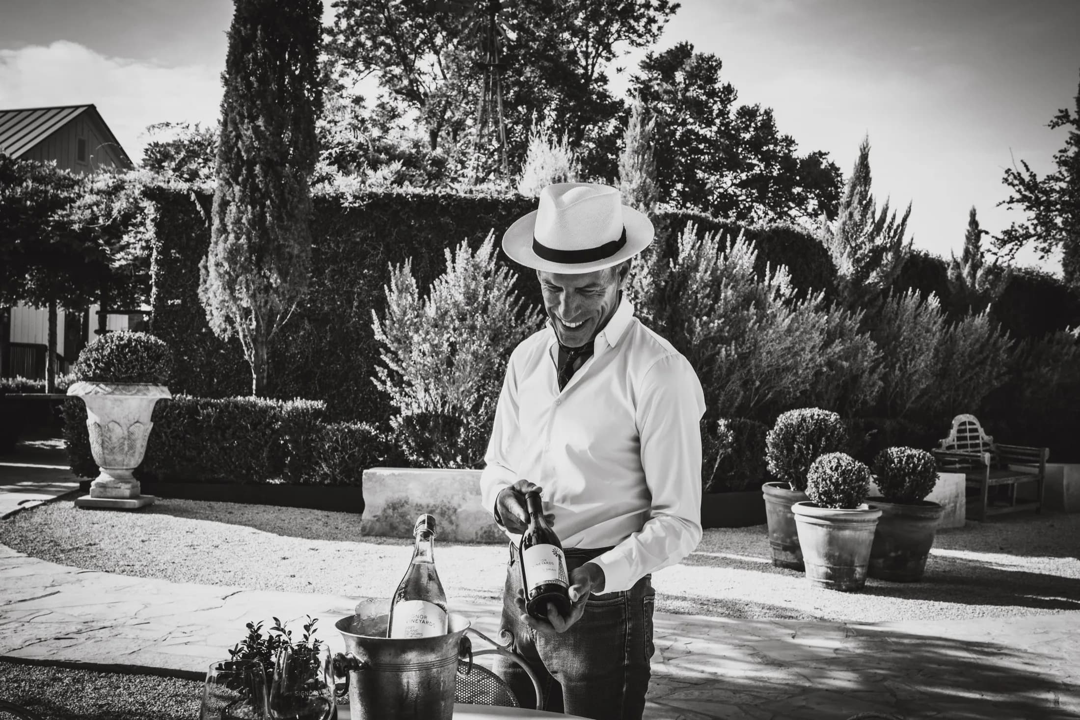 Andre Boada pours sparkling wine in a Hill Country garden.