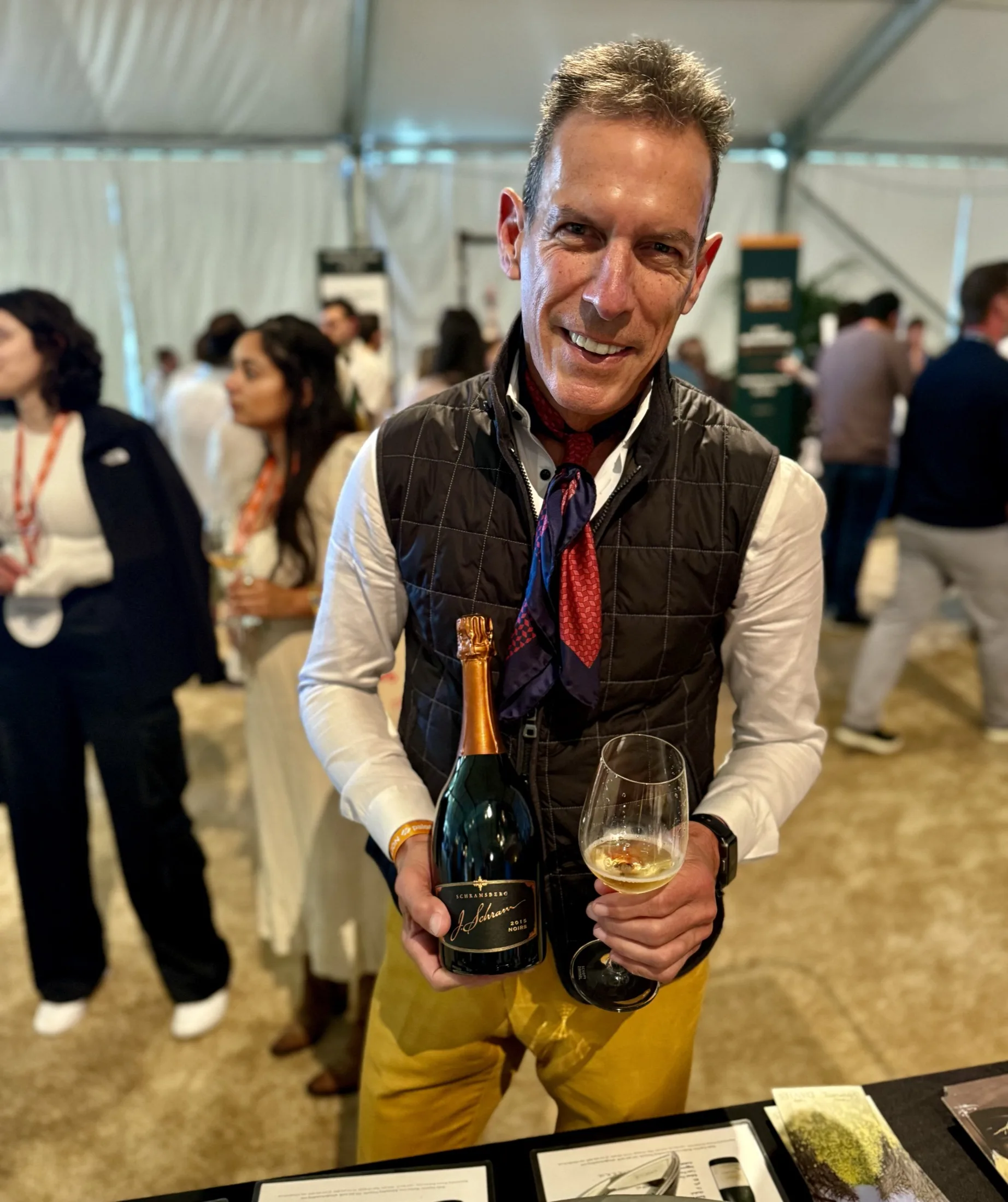 Andre Boada welcomes guests with a bottle at a festival tasting.