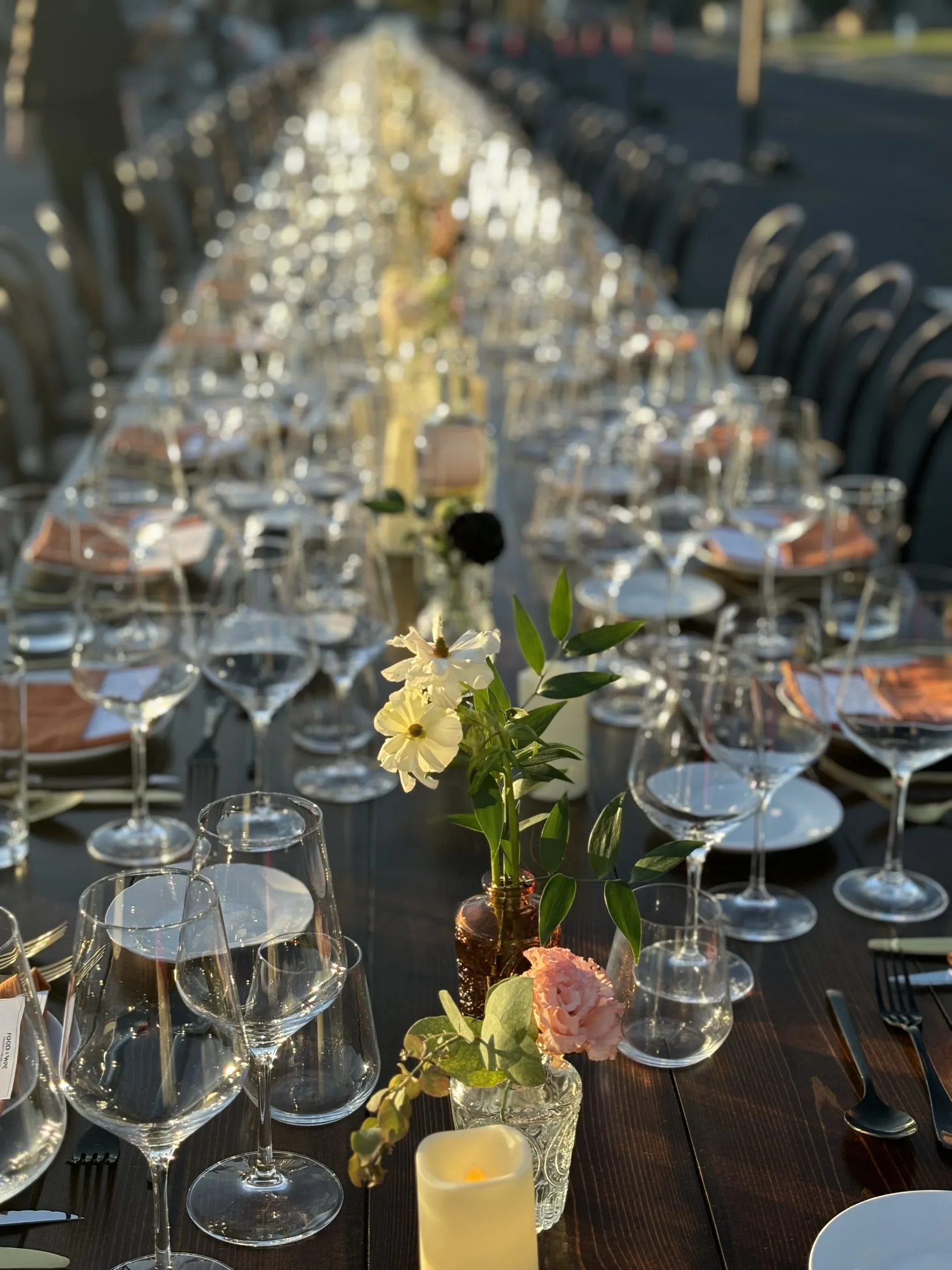 A long table set for a VinoCadre gathering at golden hour.